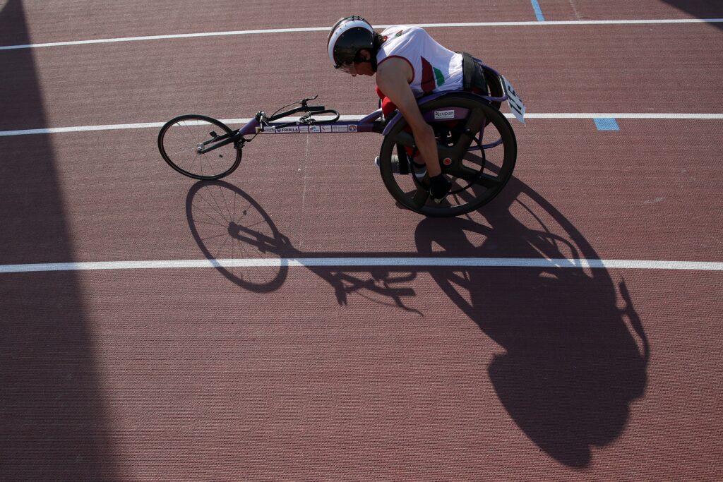 A wheelchair racer is pictured from above on track